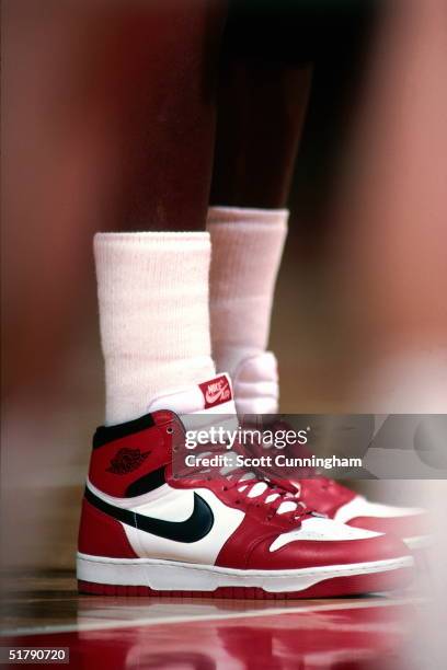 Michael Jordan of the Chicago Bulls stands wearing Nike sneakers against the Atlanta Hawks during an NBA game circa 1986 at the Omni in Atlanta,...