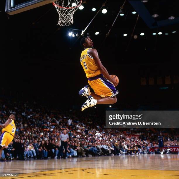 Kobe Bryant of the Los Angeles Lakers goes up for a reverse slam dunk against the Minnesota Timberwolves during an NBA game at the Staples Center...
