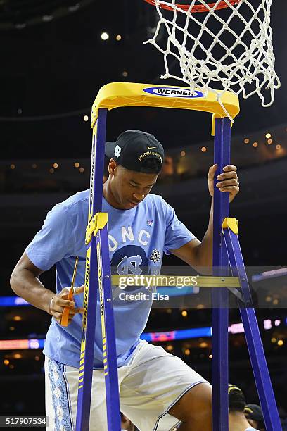 Isaiah Hicks of the North Carolina Tar Heels climbs up the ladder to cut down the net after defeating the Notre Dame Fighting Irish during the 2016...