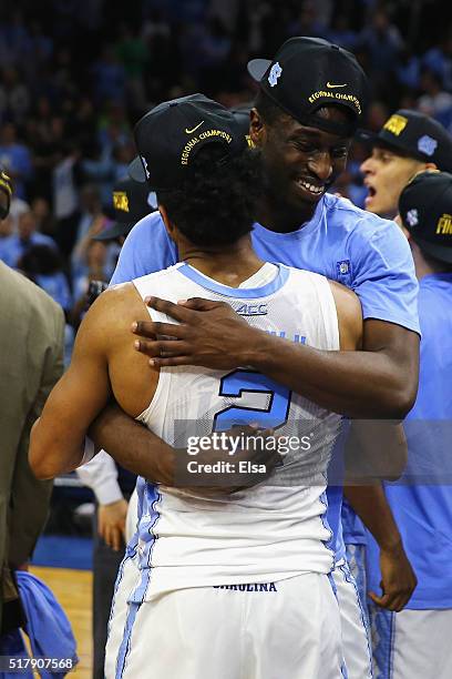 Joel Berry II of the North Carolina Tar Heels hugs Theo Pinson after defeating the Notre Dame Fighting Irish with a score of 74 to 88 in the 2016...