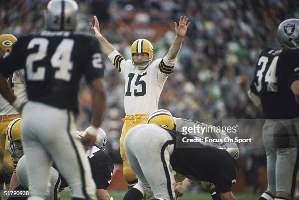 Green Bay Packers quarterback Bart Starr raises his hands before readying his teammates for the snap during Superbowl II against the Oakland Raiders...