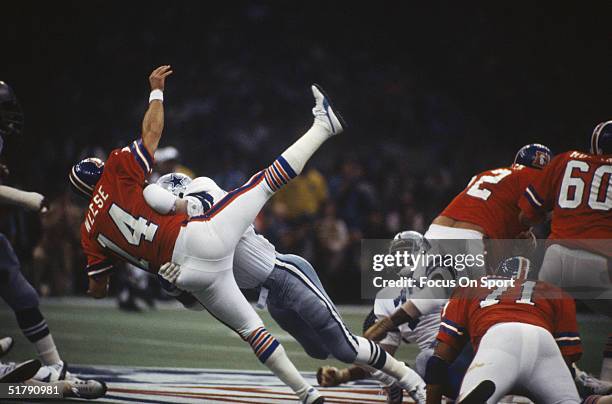 Denver Broncos quarterback Norris Weese is tackled by a Dallas Cowboy as players react to the play during Super Bowl XII at the Superdome on January...