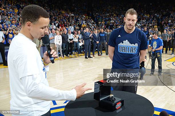 Stephen Curry of the Golden State Warriors presents former teammate David Lee of the Dallas Mavericks his championship ring prior to the game on...