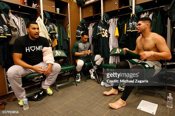 Felix Doubront, Josh Rodriguez and Renato Nunez of the Oakland Athletics relax in the clubhouse during a spring training workout at Fitch Park on...