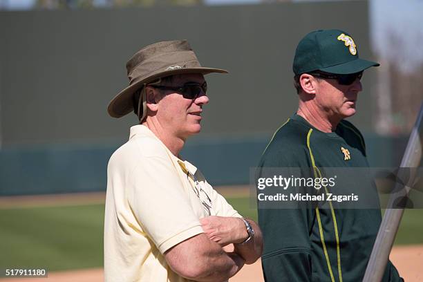 Executive Vice President of Baseball Operations Billy Beane of the Oakland Athletics stands on the field with Manager Bob Melvin during a spring...