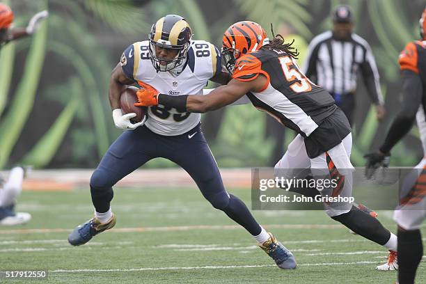 Emmanuel Lamur of the Cincinnati Bengals makes the hit on Jared Cook of the St. Louis Rams during their game at Paul Brown Stadium on November 29,...