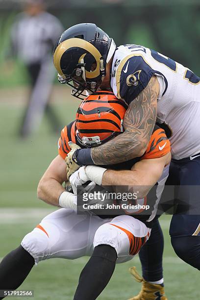 James Laurinaitis of the St. Louis Rams makes the tackle on Ryan Hewitt of the Cincinnati Bengals during their game at Paul Brown Stadium on November...