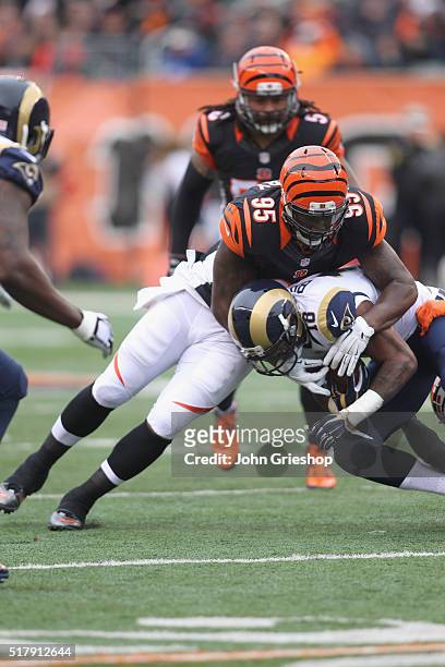 Wallace Gilberry of the Cincinnati Bengals makes the hit on Kenny Britt of the St. Louis Rams during their game at Paul Brown Stadium on November 29,...