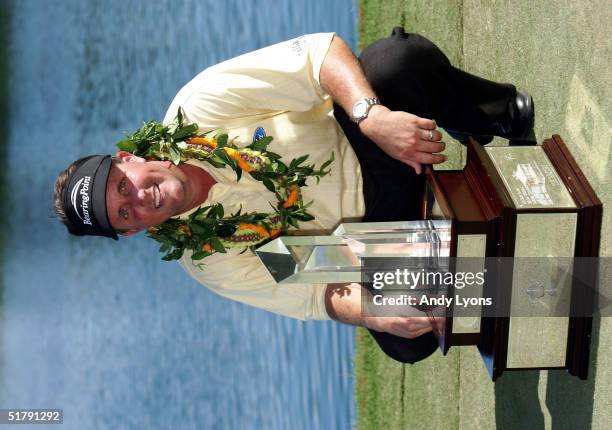 Phil Mickelson is pictured with the winner's trophy after winning the 22nd PGA Grand Slam of Golf on November 24, 2004 at the Poipu Bay Golf Course...