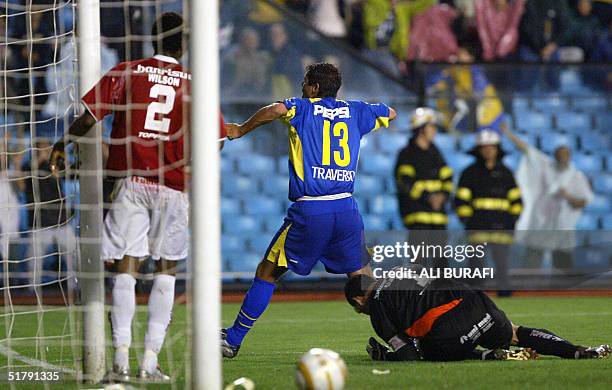 Cristian Traverso of Boca Juniors of Argentina, celebrates between goalkeeper Clemer and defender Wilson after scoring the first goal against...