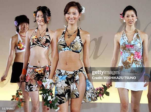 New campaign girl for Japanese apparel giant Toray, Sayaka Ogata , and other models display new bathing suits during a show featuring Toray's 2005...