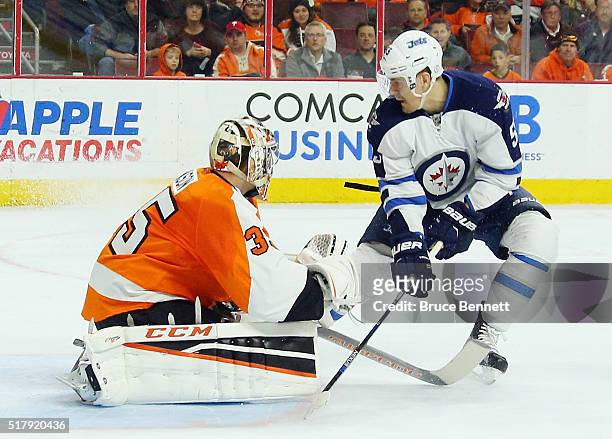 Mark Scheifele of the Winnipeg Jets misses a first period deflection against Steve Mason of the Philadelphia Flyers at the Wells Fargo Center on...