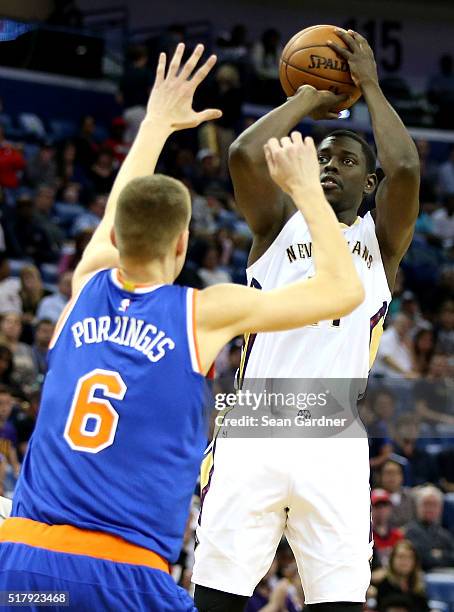 Jrue Holiday of the New Orleans Pelicans shoots over Tony Wroten of the New York Knicks during the first half at the Smoothie King Center on March...