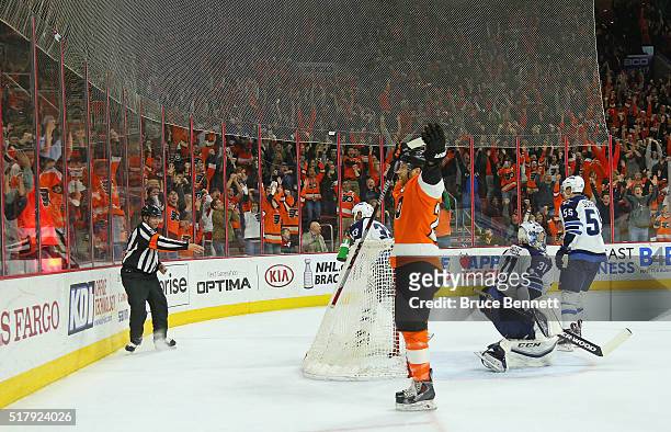 Claude Giroux of the Philadelphia Flyers celebrates his game winning goal at 4:46 of overtime against Ondrej Pavelec of the Winnipeg Jets at the...