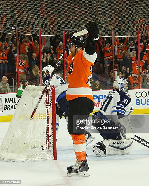 Claude Giroux of the Philadelphia Flyers celebrates his game winning goal at 4:46 of overtime against Ondrej Pavelec of the Winnipeg Jets at the...