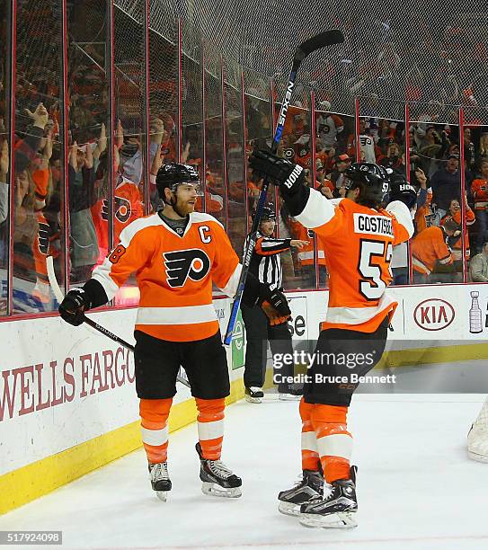 Claude Giroux of the Philadelphia Flyers celebrates his game winning goal at 4:46 of overtime against Ondrej Pavelec of the Winnipeg Jets and is...