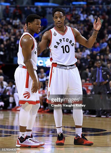 Kyle Lowry and DeMar DeRozan of the Toronto Raptors talk during the first half of an NBA game against the Oklahoma City Thunder at the Air Canada...