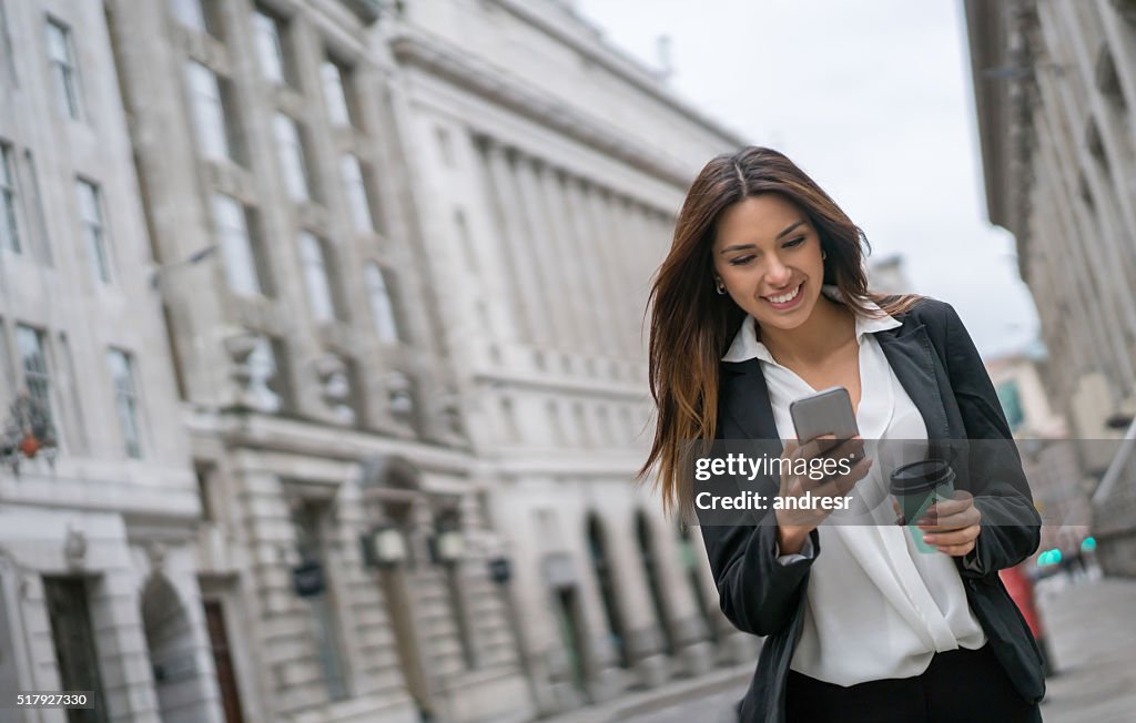 Business woman texting on her phone