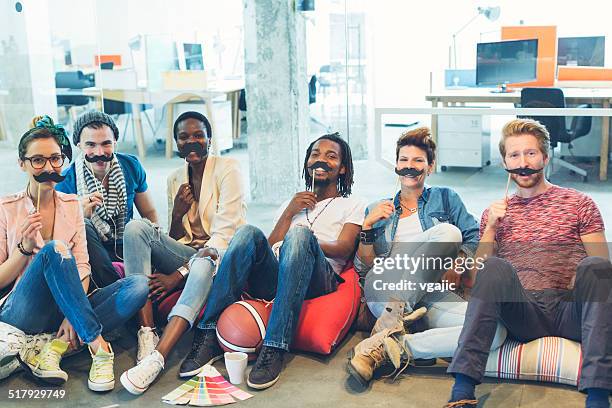 multi ethnich group of young designers involved in movember project. - fake man stockfoto's en -beelden