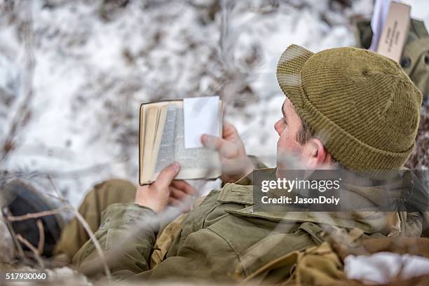 ww ii: front lines in the snow reading bible - bible reenactment stock pictures, royalty-free photos & images