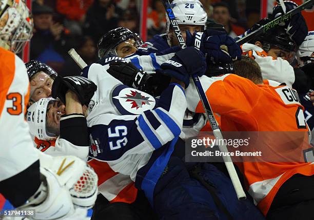 Jakub Voracek and Radko Gudas of the Philadelphia Flyers combine on Mark Scheifele of the Winnipeg Jets at the Wells Fargo Center on March 28, 2016...