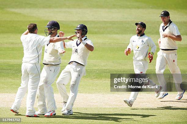 Jon Holland of the VIC Bushrangers is congratulated by teammates after he got the wicket of Alex Ross of the Redbacks during day 4 of the Sheffield...