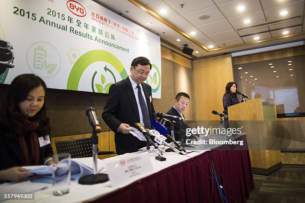 Wang Chuanfu, chairman of BYD Co., second left, takes a seat after speaking at a news conference in Hong Kong, China, on Tuesday, March 29, 2016. BYD...