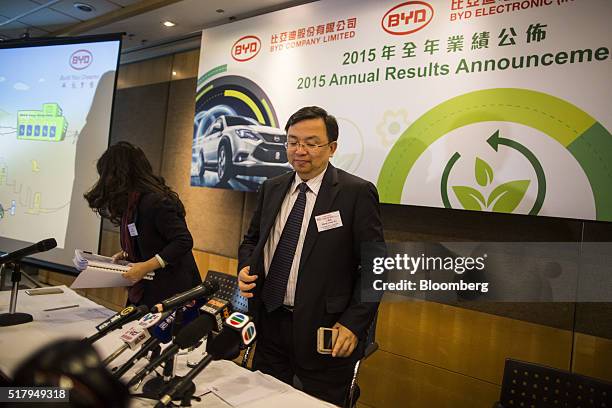 Wang Chuanfu, chairman of BYD Co., center, prepares to leave a news conference in Hong Kong, China, on Tuesday, March 29, 2016. BYD has become the...