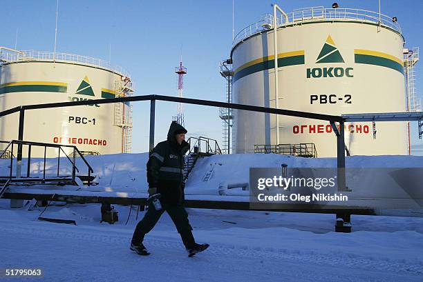 Workers from contractors company of YUKOS giant oil company build at a new pumping station November 10, 2004 on the Ust-Balick oil field near...