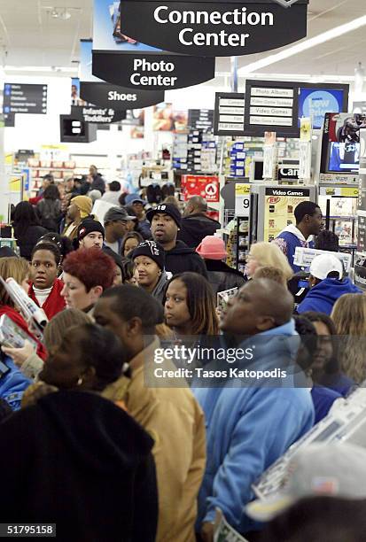 Early morning shoppers pack the aisles at a Wal-Mart store November 26, 2004 in Hobart, Indiana. The Friday after Thanksgiving, called "Black...