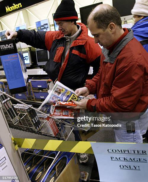 Tony Osika of Hobart and Jim Gazdick of Merrillville look at sale items inside a Best Buy electronics store November 26, 2004 in Hobart, Indiana. The...