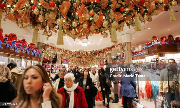 People shop in Macy's department store November 26, 2004 in New York City. The Friday after Thanksgiving, called "Black Friday," is one of the...