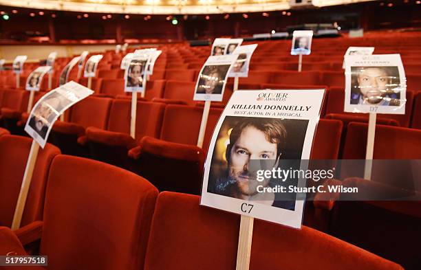 Seat markers with faces of nominees are seen in position during the 'heads on sticks' photocall ahead of the Olivier Awards, which takes place on...