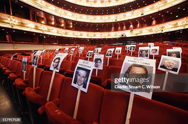 Seat markers with faces of nominees are seen in position during the 'heads on sticks' photocall ahead of the Olivier Awards, which takes place on...