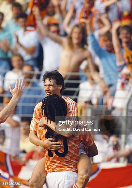 Marco Van Basten celebrates his hat trick goal with Ruud Gullitt during the 1988 European Championship match between England and Netherlands at the...