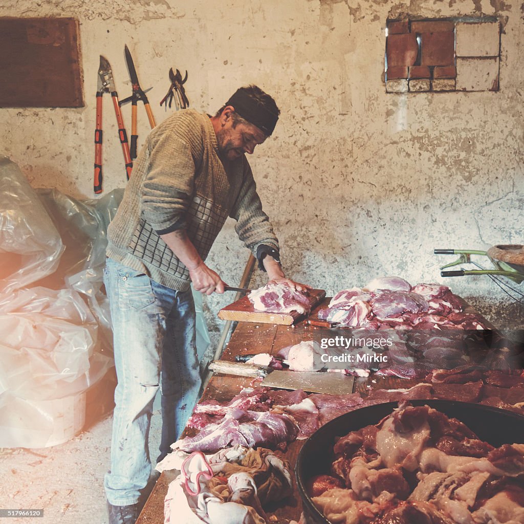 Selbständige Schneiden Schwein und Ziegenfleisch auf einem Holztisch
