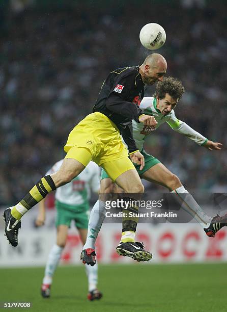 Jan Koller of Dortmund in action against Frank Baumann of Bremen during The Bundesliga match between Werder Bremen and Borussia Dormund at The Weser...