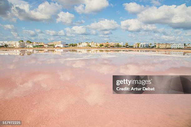 cloudy sky reflected on the formentera´s saltpans. - formentera stock pictures, royalty-free photos & images