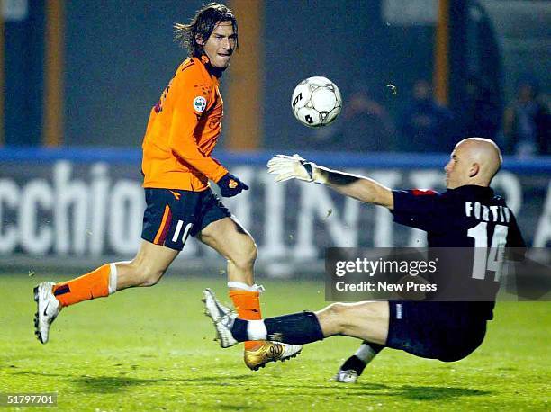 Francesco Totti of AS Roma shoots against Marco Fortin of AC Siena during their Serie A match at the A. Franchi Stadium November 27, 2004 in Siena,...