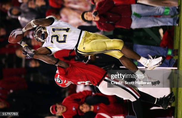 Calvin Johnson of Georgia Tech leaps for the football as Paul Oliver of Georgia defends during the game between Georgia and Georgia Tech on November...