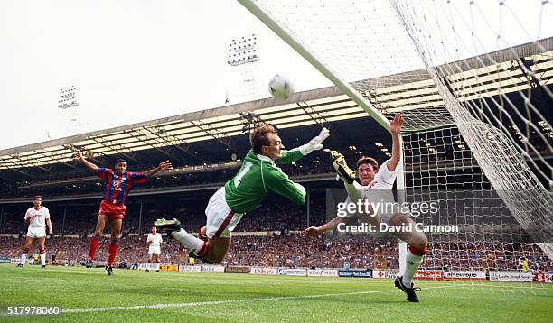 Palace striker Mark Bright celebrates as Manchester United goalkeeper Jim Leighton and defender Steve Bruce fail to keep out the first Crystal Palace...