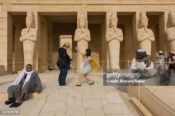 Chinese-speaking tourist group enjoy the experience of visiting the ancient Egyptian Temple of Hatshepsut near the Valley of the Kings, Luxor, Nile...