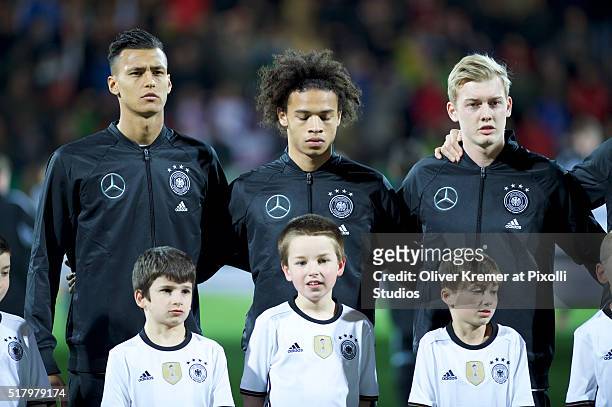 Forward Davie Selke of Germany , Forward Leroy Sané of Germany and Midfielder Julian Brandt of Germany during the national anthems at Frankfurter...