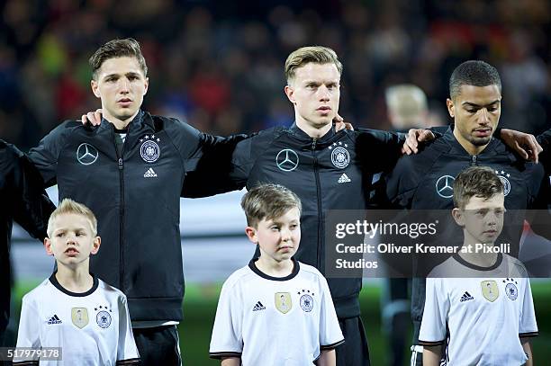 Defense Niklas Stark of Germany , Defense Yannick Gehrhardt of Germany and Defense Jeremy Toljan of Germany during the national anthem at Frankfurter...