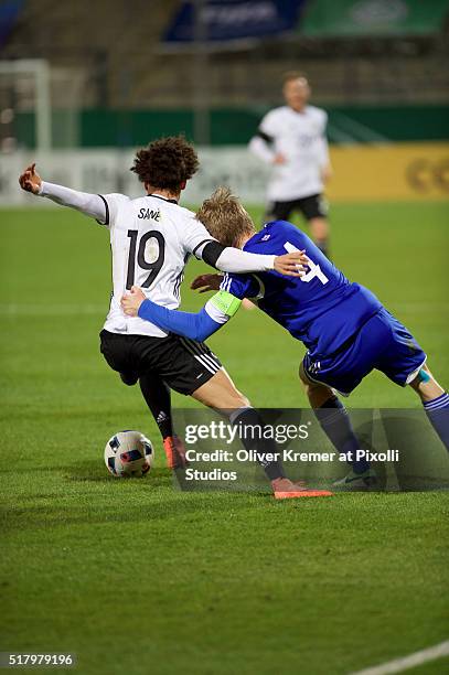 Forward Leroy Sané of Germany and Andrias H. Eriksen of Faeroer Islands fighting for the ball at Frankfurter Volksbank-Stadion during the...