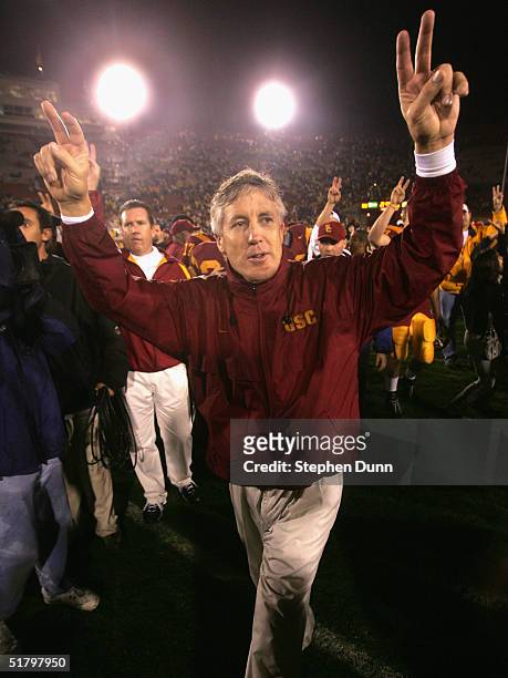 Head coach Pete Carroll of the USC Trojans celebrates following the game with the Notre Dame Fighting Irish on November 27, 2004 at the Los Angeles...