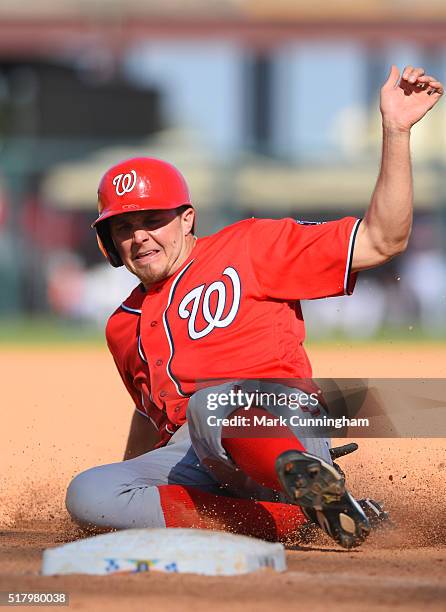 Tony Campana of the Washington Nationals slides safely into third base during the Spring Training game against the Detroit Tigers at Joker Marchant...