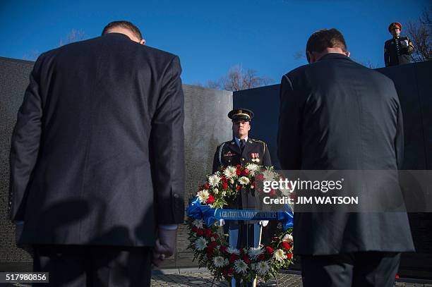 Secretary of Defense Ashton Carter and Veterans Affairs Secretary Robert McDonald place a wreath at the Vietnam Veterans Memorial in Washington, DC,...