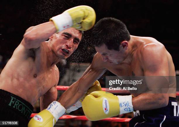 Marco Antonio Barrera follows through after landing a right to the face of Erik Morales during a fight for the WBC World Super Featherweight...