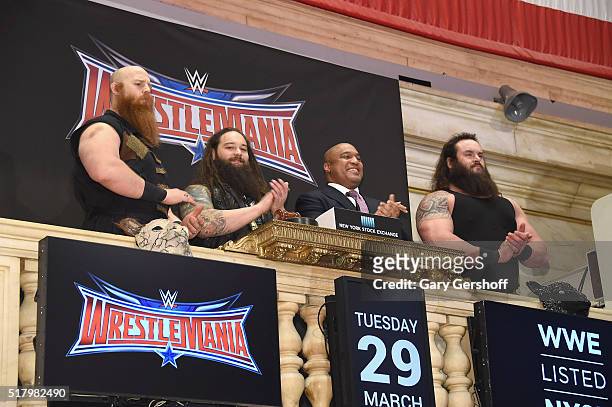 Wrestlers Erik Rowan and Bray Wyatt, Global Head of Capital Markets at NYSE, Garvis Toler and WWE wrestler Braun Strowman ring the New York Stock...